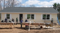 a yellow house with people working